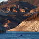 A bathtub ring of light minerals shows the high water line near the Hoover Dam.